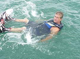 Man wearing a life vest while on water