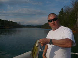 A picture of a man holding caught fish