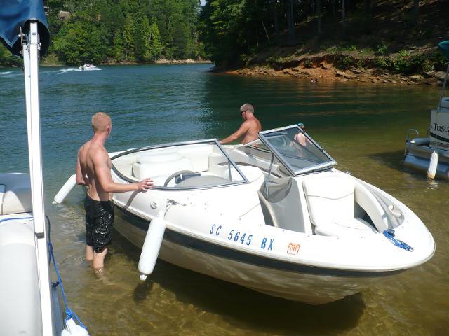 Two men inspecting the boat