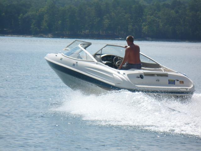 Image of man driving a boat